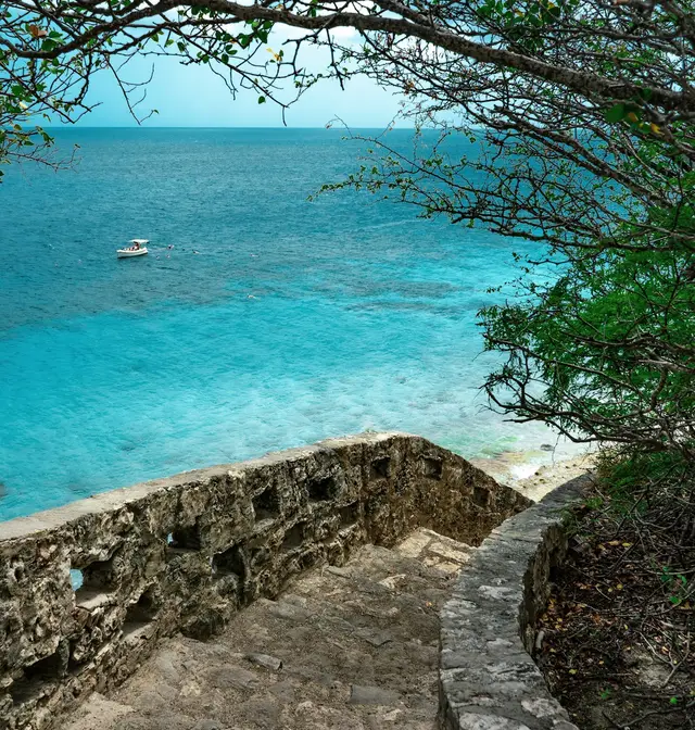 Old stone steps leading down to the turquoise Caribbean Sea at 1000 Steps, Bonaire